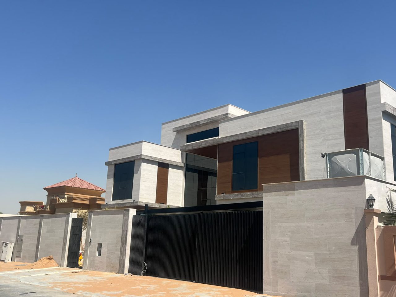 Al Warqa Villa 21 exterior facade with Travertine limestone cladding and curtain wall glazing