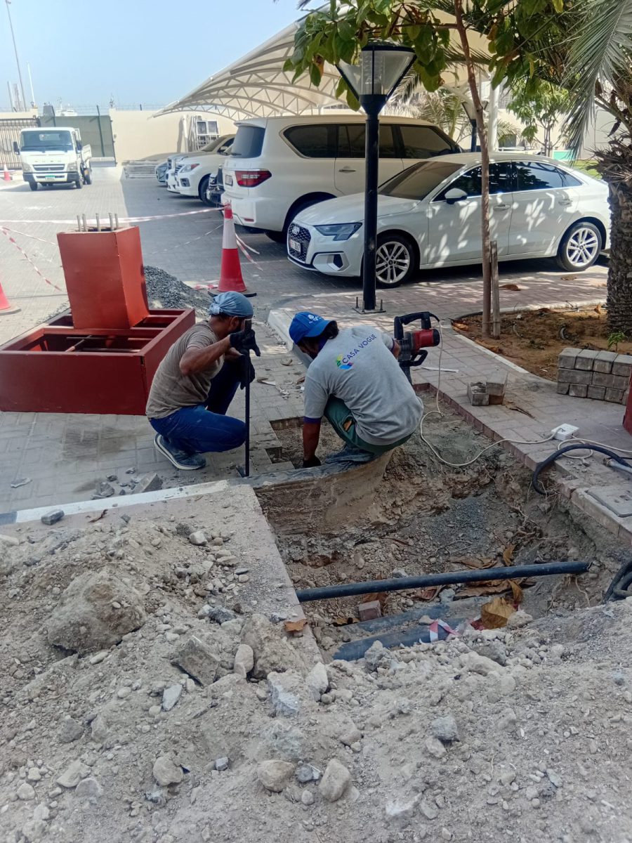 On-site excavation and casting of reinforced concrete foundation blocks with rebar cages for canopy support